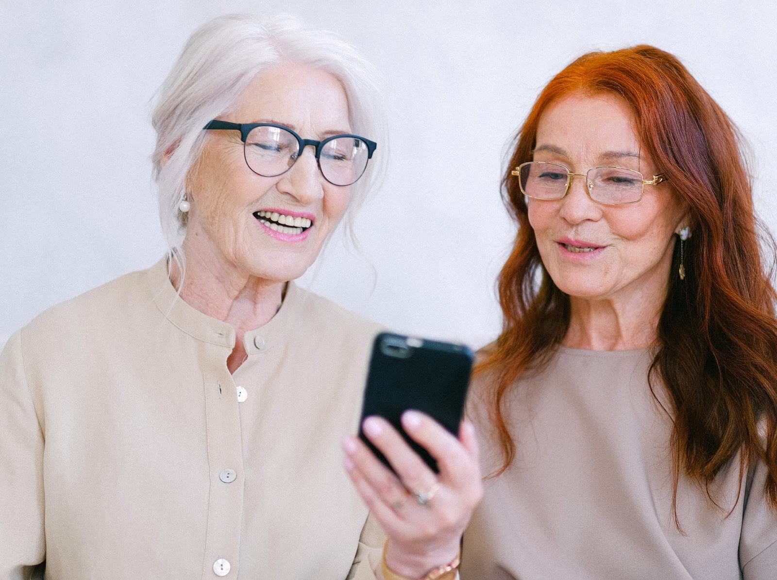 Two elderly women using a voice memo app